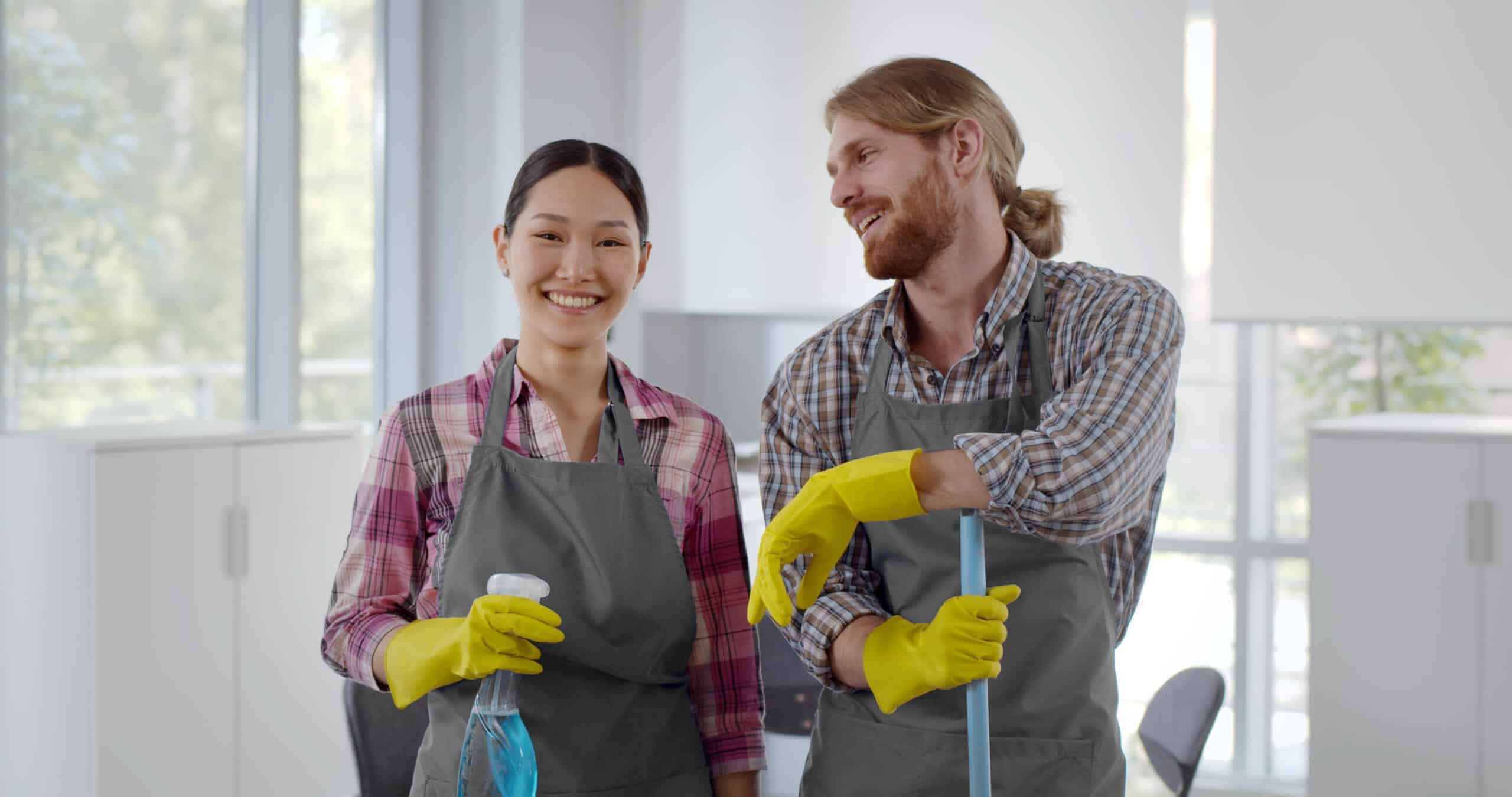 Professional cleaners smiling together