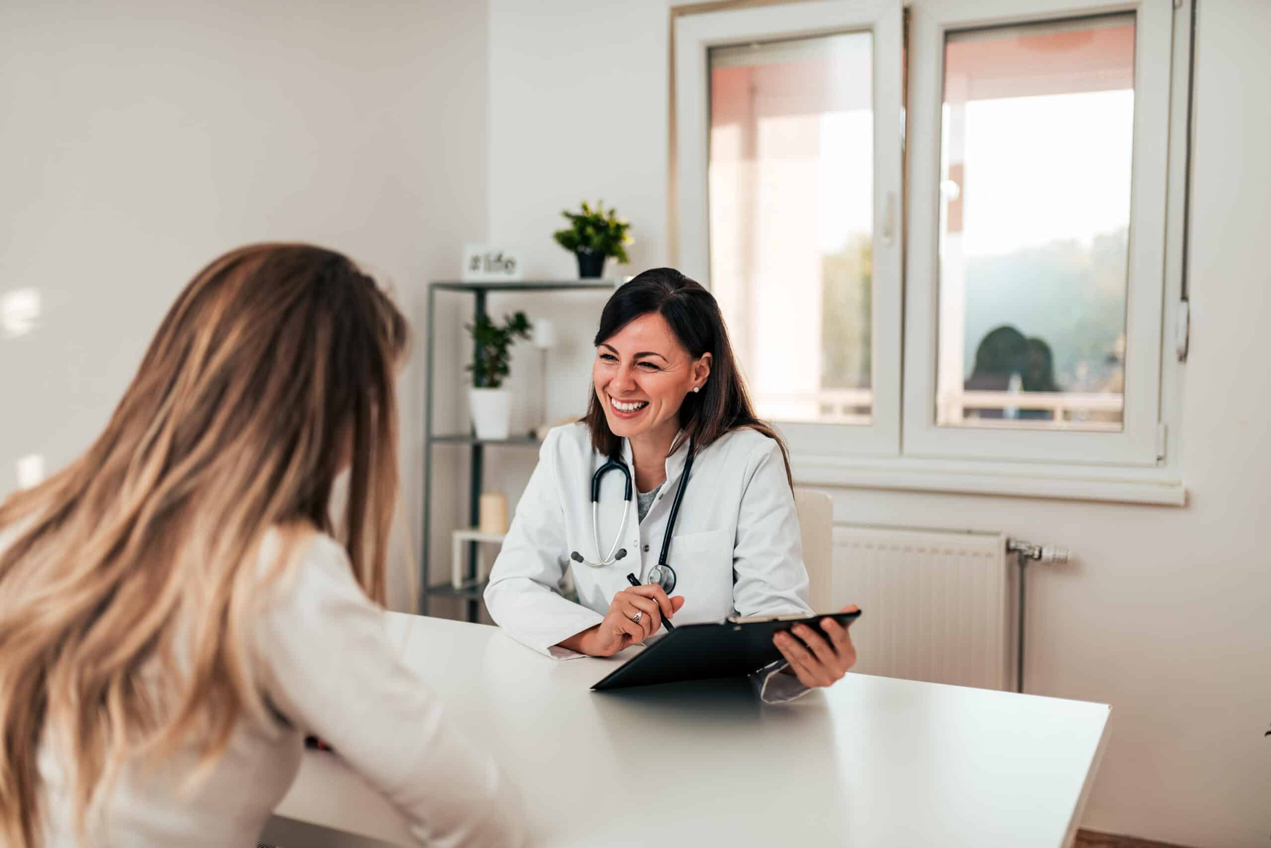 Medical receptionist helping patient in clinic