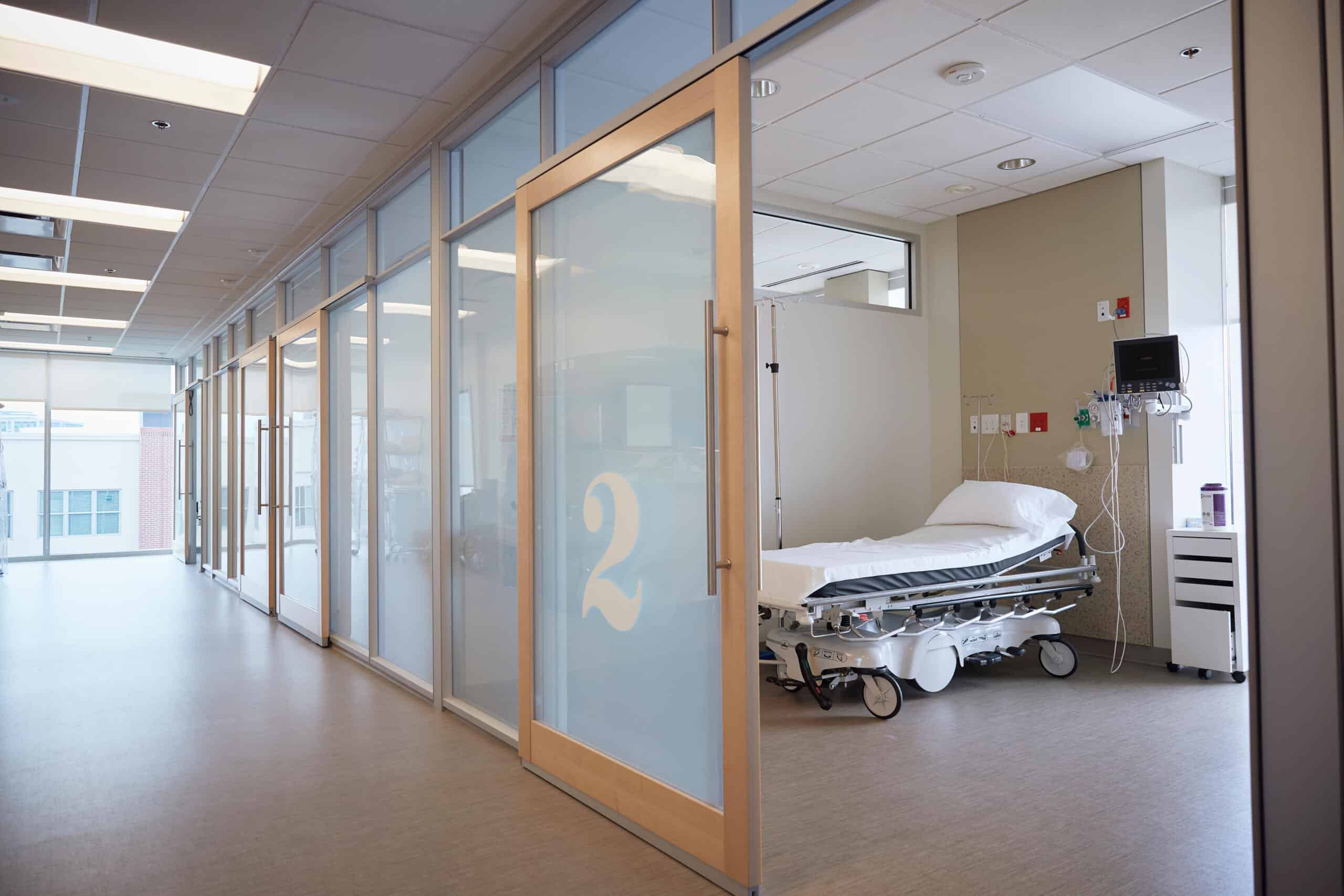 Empty hospital room viewed from hallway