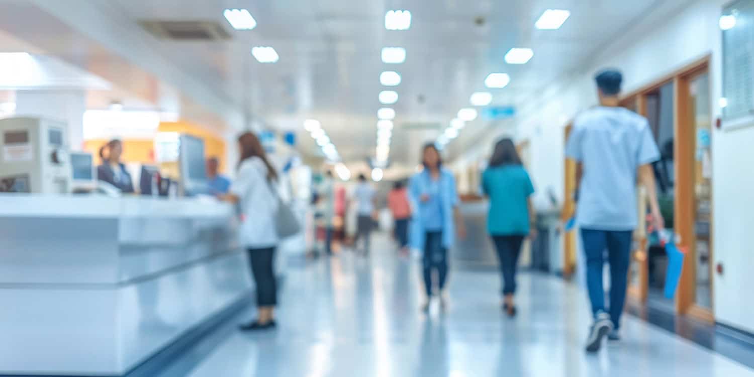 Busy hospital corridor with medical professionals walking through