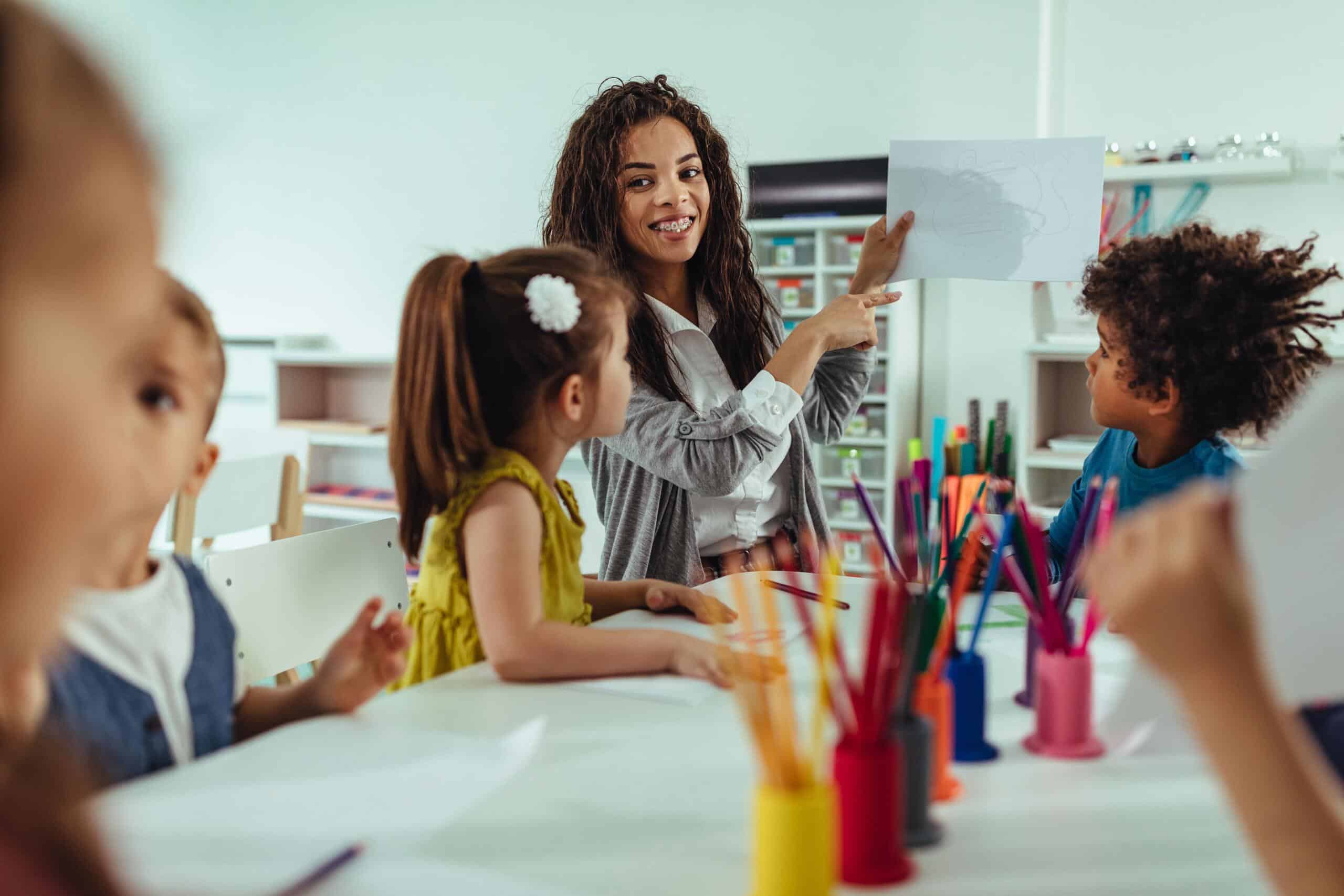 Teacher showing picture to childcare class