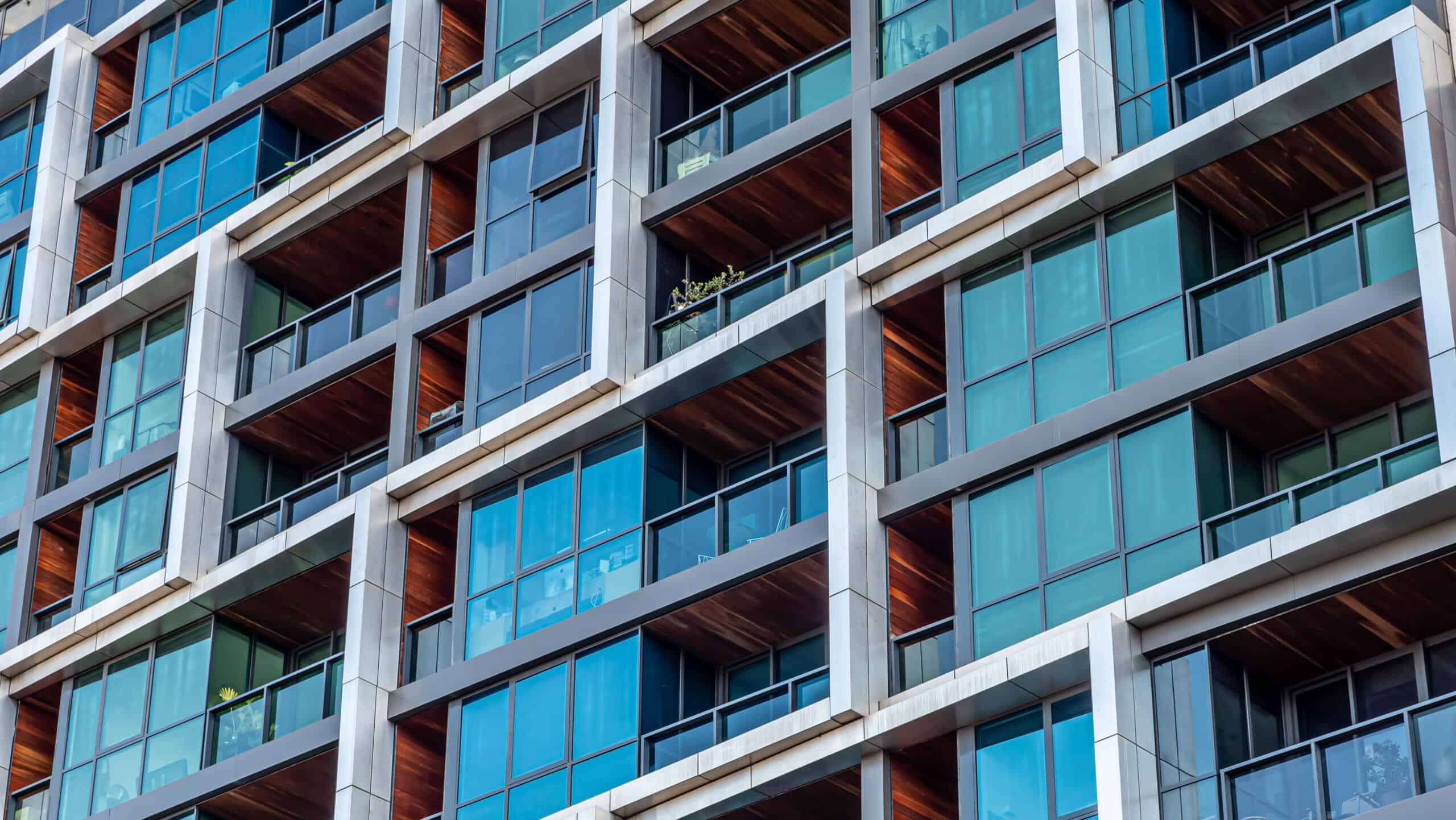 Modern multi-dwelling buildings, balconies close up. Family apartments in a strata living scheme of common property.